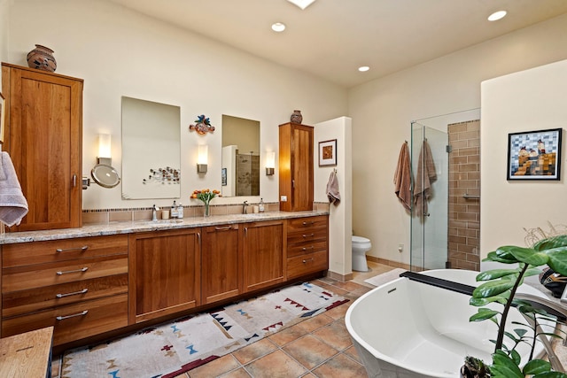 972 Indian Ridge Rd, Santa Fe, NM 87501 - bathroom with tile patterned flooring, recessed lighting, a freestanding bath, double vanity, and a stall shower