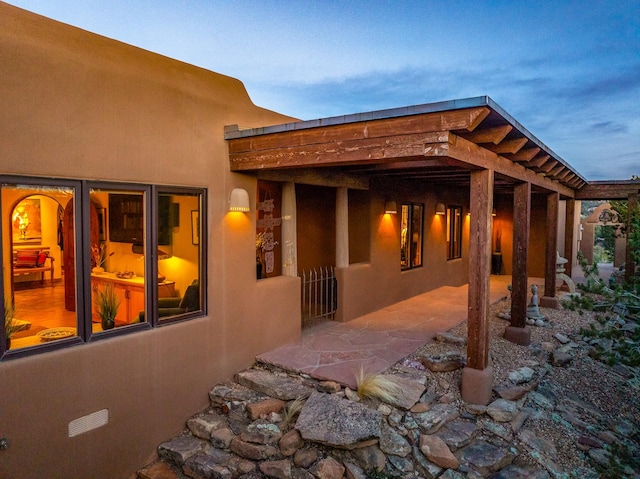 972 Indian Ridge Rd, Santa Fe, NM 87501 - view of property exterior with stucco siding and a patio