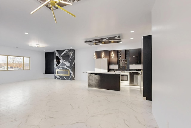 kitchen with a center island, pendant lighting, light countertops, open floor plan, and modern cabinets