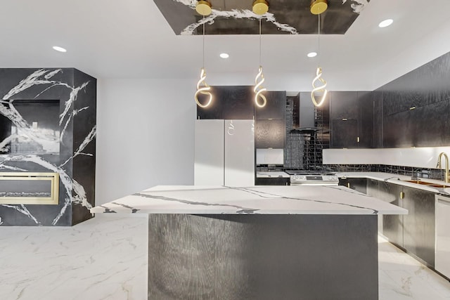 kitchen with marble finish floor, hanging light fixtures, appliances with stainless steel finishes, modern cabinets, and wall chimney exhaust hood