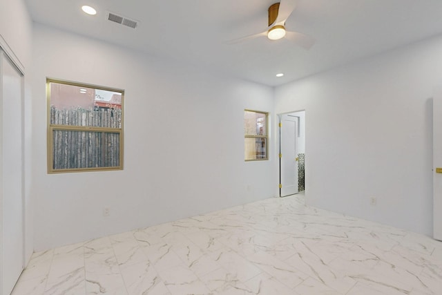 unfurnished bedroom featuring marble finish floor, ceiling fan, visible vents, and recessed lighting