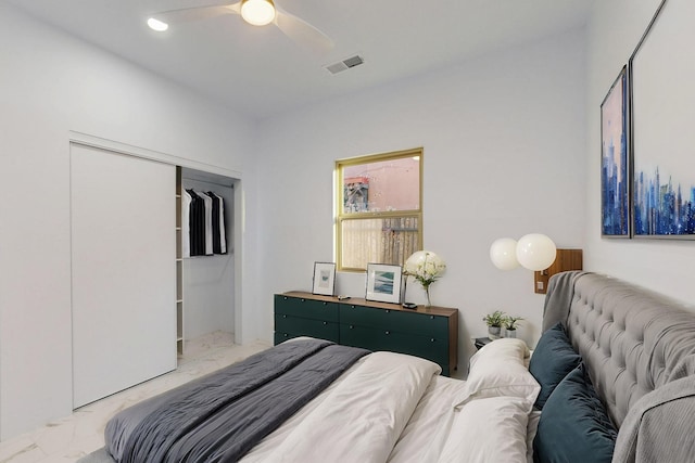 bedroom featuring a closet, marble finish floor, visible vents, and ceiling fan