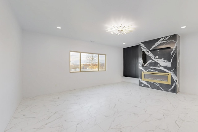 interior space featuring recessed lighting and marble finish floor