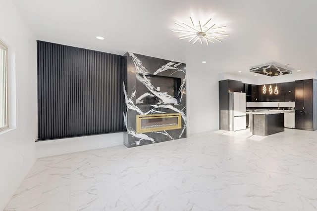 living area featuring recessed lighting and marble finish floor