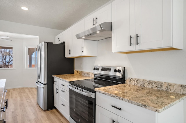 kitchen with light stone counters, appliances with stainless steel finishes, white cabinetry, and under cabinet range hood