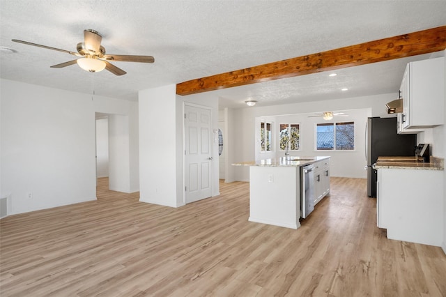 kitchen with white cabinets, a sink, a textured ceiling, an island with sink, and dishwasher