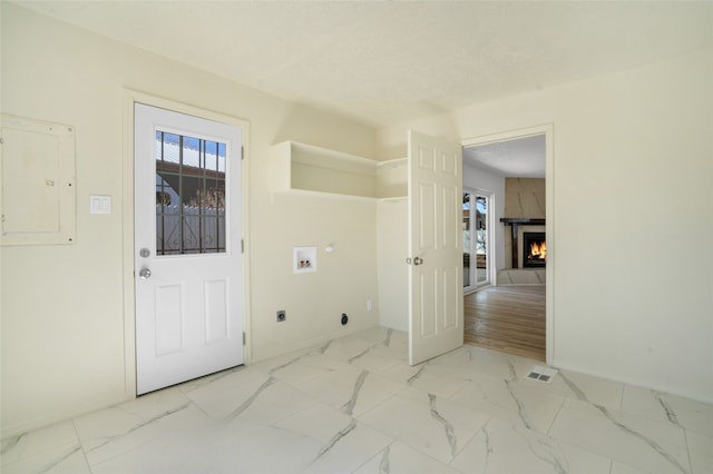 washroom featuring marble finish floor, hookup for a washing machine, electric dryer hookup, and electric panel