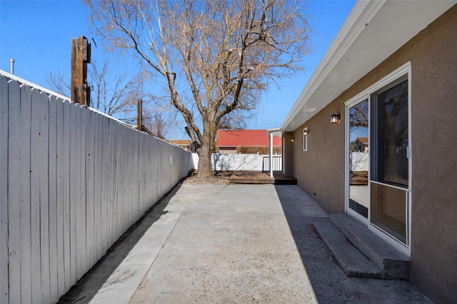 view of patio featuring fence