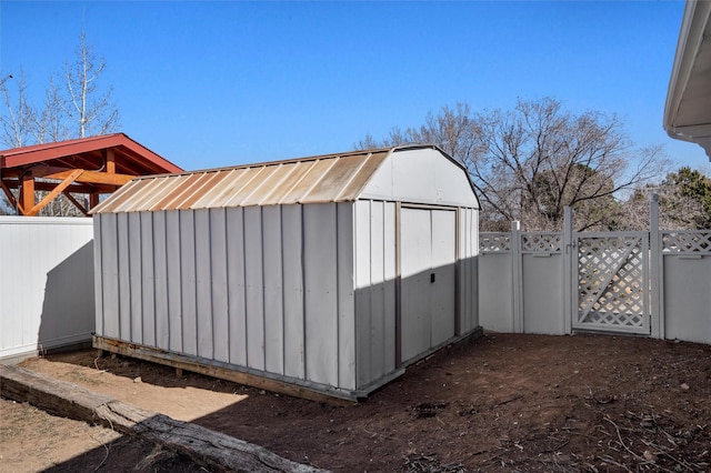 view of shed with a fenced backyard and a gate