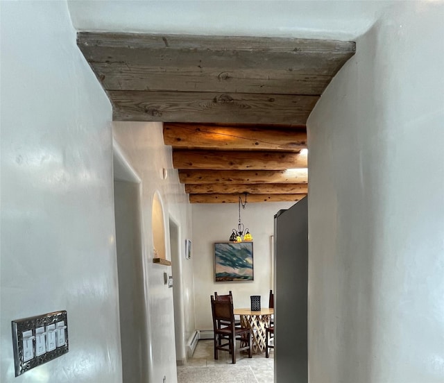 corridor featuring a baseboard radiator, arched walkways, and beam ceiling