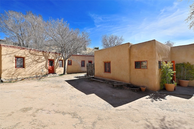 back of house featuring stucco siding