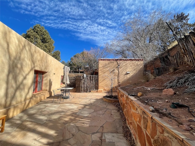 view of patio / terrace featuring fence