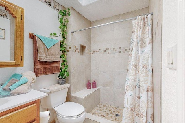 full bathroom featuring a textured ceiling, toilet, a shower stall, and vanity