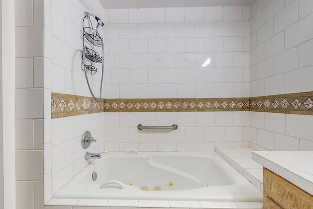 bathroom featuring a tub with jets and vanity