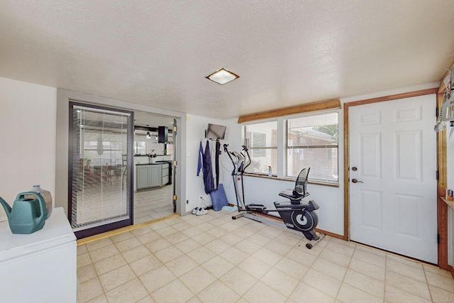 workout area featuring a textured ceiling