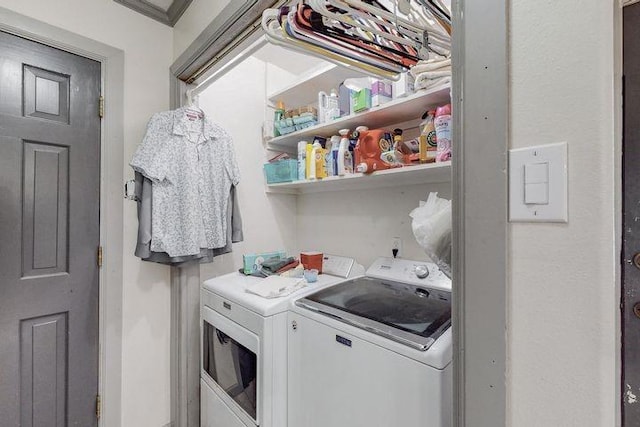 clothes washing area featuring laundry area and washing machine and dryer