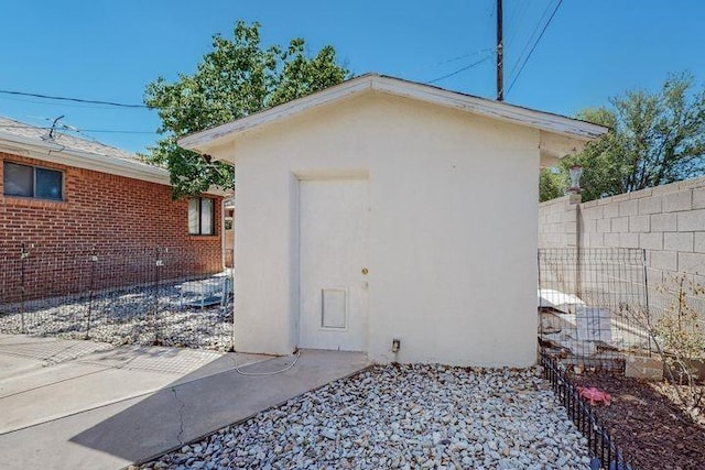 view of outbuilding featuring fence