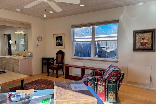 living area with recessed lighting, light wood-style flooring, a ceiling fan, wood ceiling, and baseboards