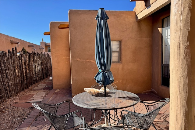 view of patio with fence and outdoor dining space