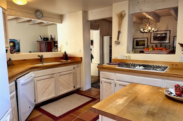 kitchen with butcher block counters, stainless steel gas stovetop, dishwasher, and decorative light fixtures