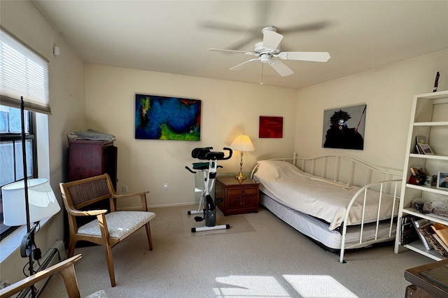 carpeted bedroom featuring a ceiling fan and baseboards