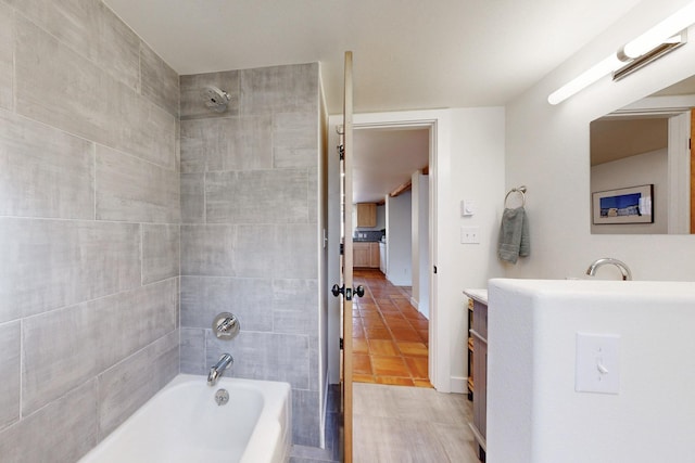 bathroom featuring tile patterned flooring, vanity, and bathing tub / shower combination