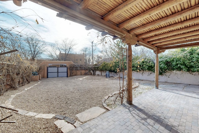 view of patio with a fenced backyard and an outdoor structure