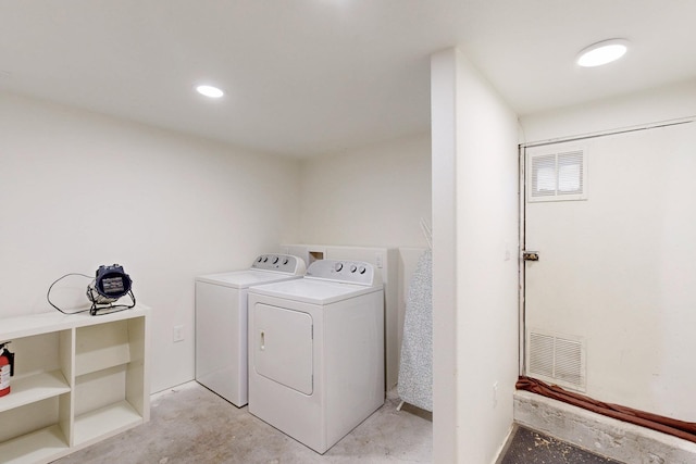 laundry area featuring washing machine and dryer, laundry area, and visible vents