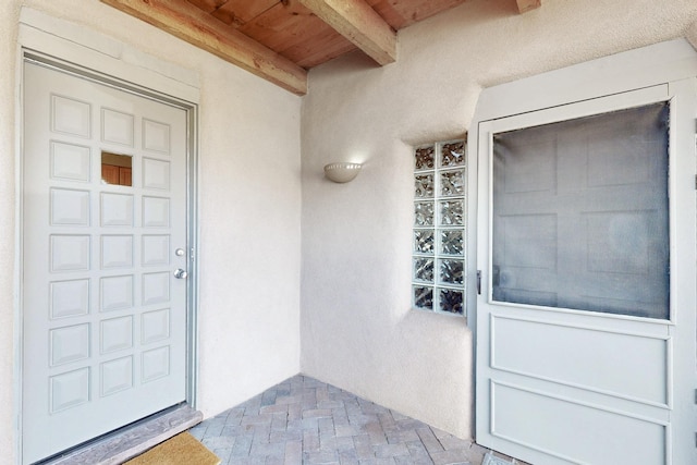 property entrance featuring stucco siding