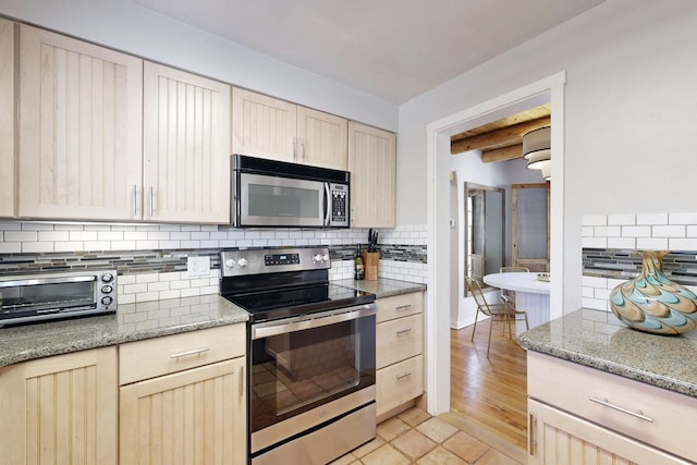 kitchen with stainless steel appliances, light brown cabinets, beamed ceiling, and backsplash