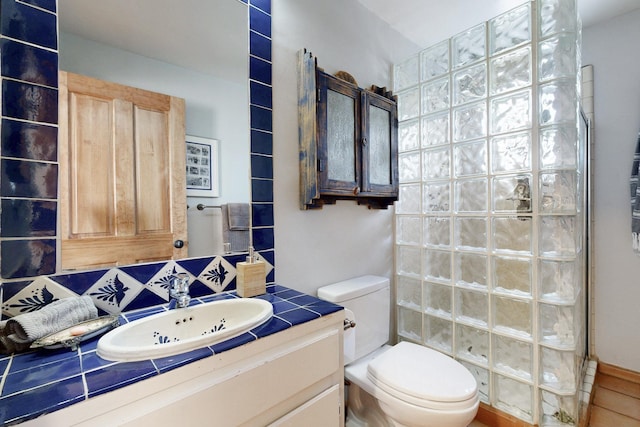 full bath with toilet, tile patterned floors, a walk in shower, and vanity