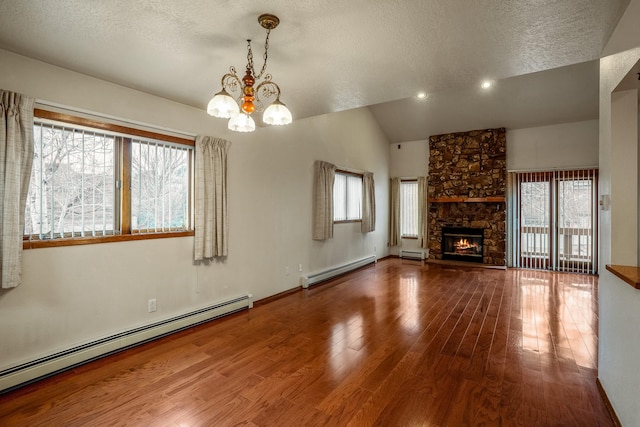 unfurnished living room featuring vaulted ceiling, a fireplace, baseboard heating, and wood finished floors