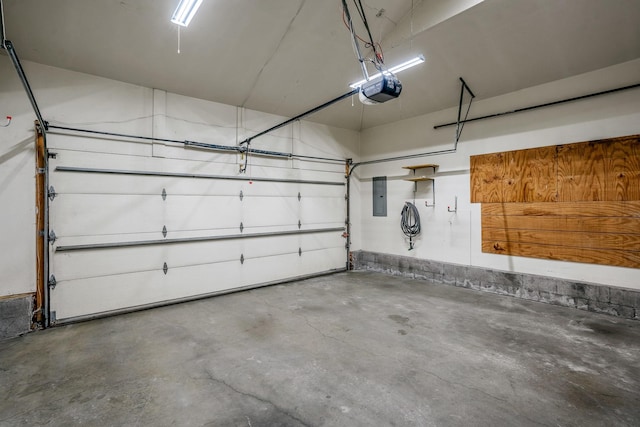 garage with a garage door opener and electric panel