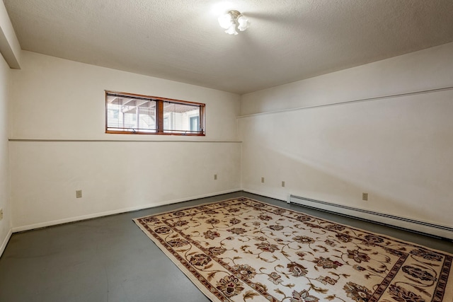 unfurnished room featuring concrete flooring, baseboards, a textured ceiling, and baseboard heating