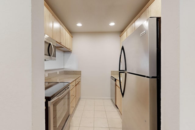 kitchen featuring appliances with stainless steel finishes, light countertops, light brown cabinets, and recessed lighting