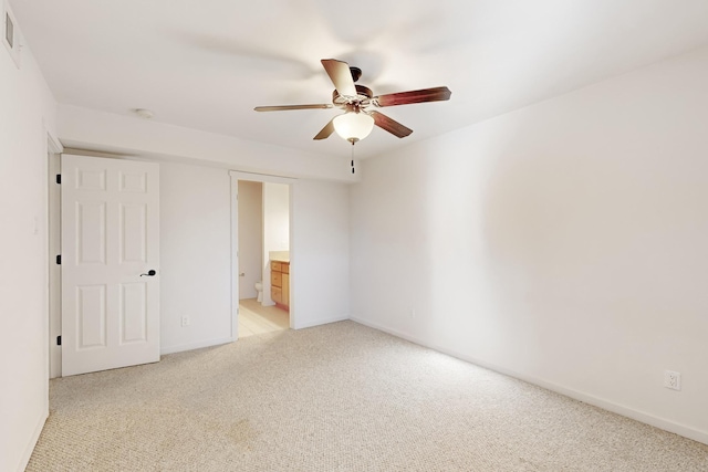 unfurnished room with light carpet, baseboards, and a ceiling fan