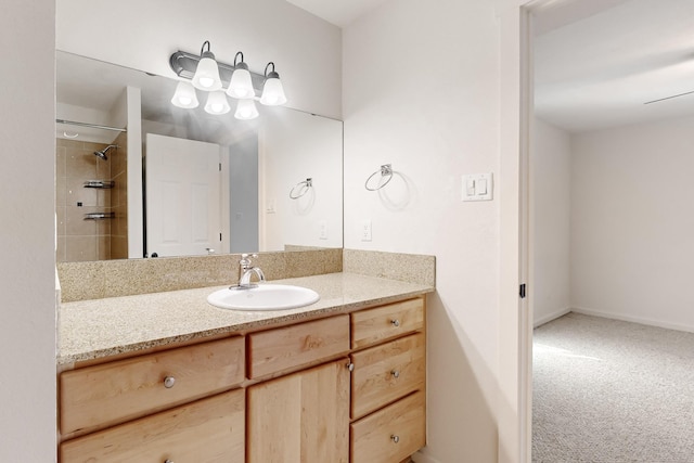 bathroom with vanity, baseboards, and walk in shower