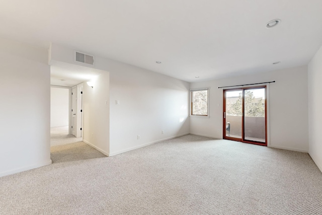 empty room with baseboards, recessed lighting, visible vents, and light colored carpet