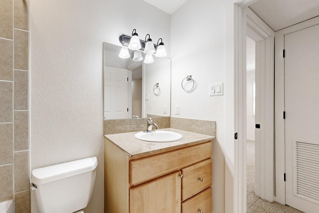 bathroom with toilet and vanity