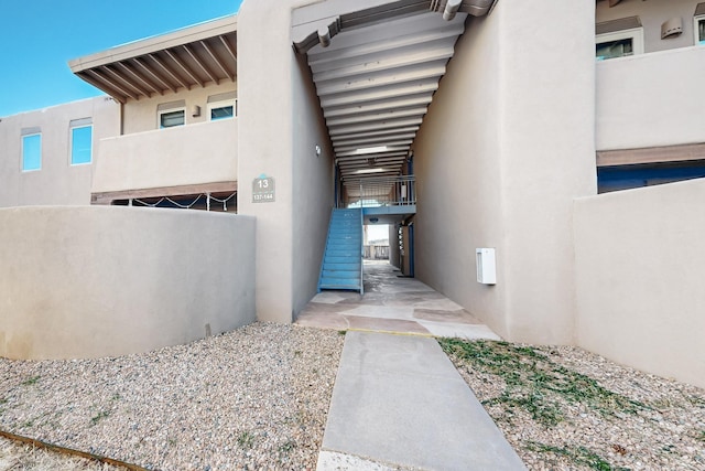 view of exterior entry with stucco siding