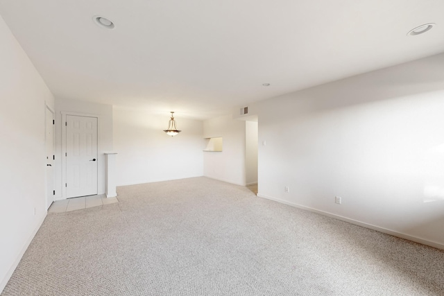 empty room featuring light carpet, baseboards, visible vents, and recessed lighting