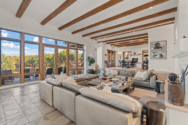 living room with marble finish floor and beamed ceiling