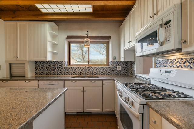 kitchen featuring white appliances, a sink, decorative backsplash, and open shelves