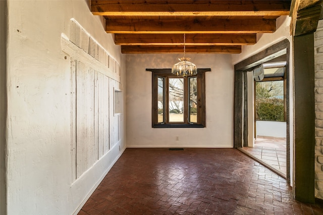 unfurnished dining area with brick floor, beam ceiling, visible vents, and a notable chandelier