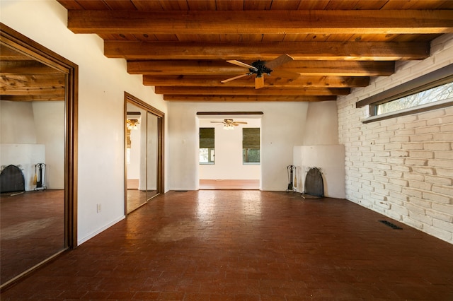 interior space featuring ceiling fan, brick floor, brick wall, visible vents, and wood ceiling