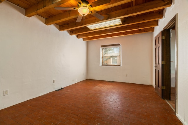 unfurnished room with ceiling fan, beam ceiling, brick floor, and wood ceiling