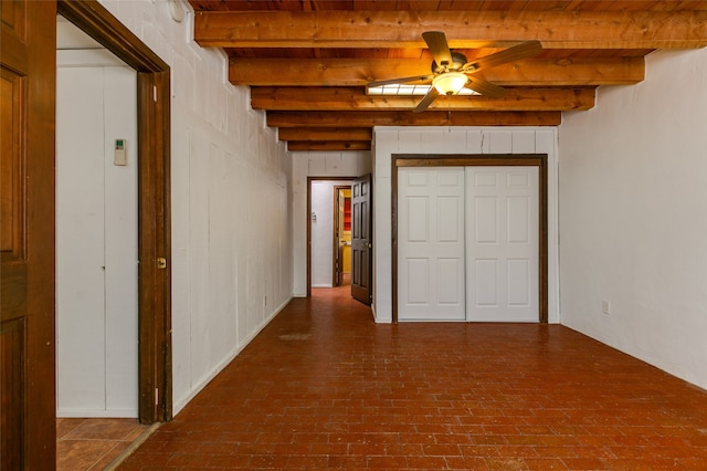 corridor with brick floor and beamed ceiling