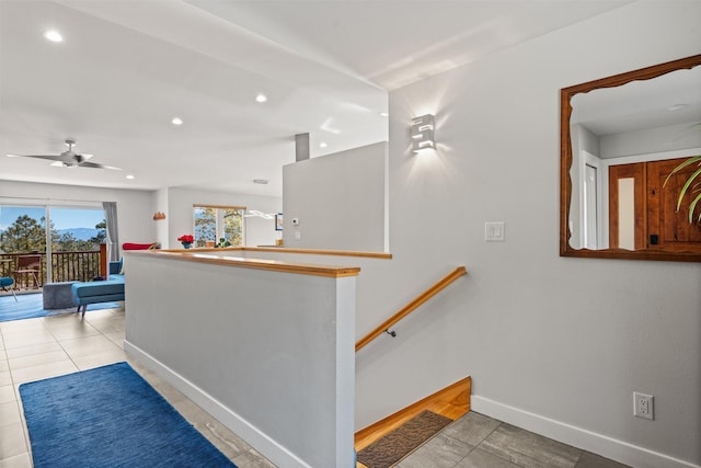 interior space featuring recessed lighting, baseboards, and an upstairs landing