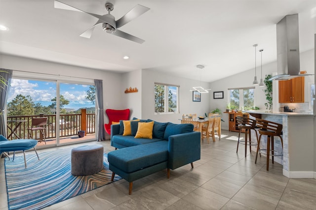 living area with recessed lighting, a healthy amount of sunlight, and vaulted ceiling