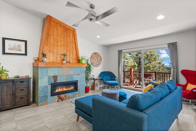 living room with a ceiling fan, a tile fireplace, and recessed lighting